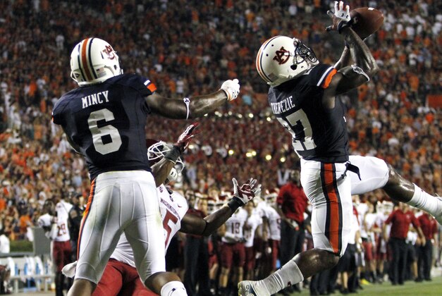 Auburn defensive back Robenson Therezie (27) intercepts a pass in the end zone intended for Washington State wide receiver Rickey Galvin (5) to stop the Cougars late in the fourth quarter of an NCAA college football game on Saturday, Aug. 31, 2013, in Auburn, Ala. (AP Photo/Butch Dill)