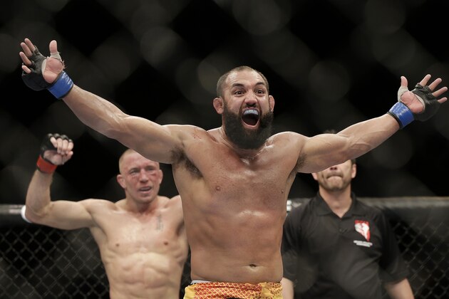 Johny Hendricks, center, reacts following a UFC 167 mixed martial arts championship welterweight bout on against Georges St. Pierre, of Canada, on Saturday, Nov. 16, 2013, in Las Vegas. St. Pierre won by split decision. (AP Photo/Isaac Brekken)
