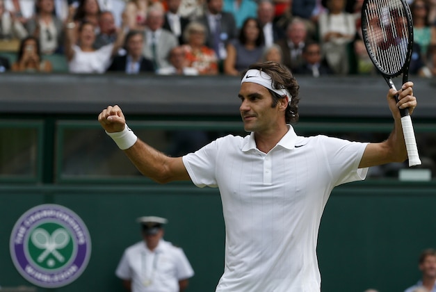 Roger Federer of Switzerland celebrates as he defeats Stan Wawrinka of Switzerland in their men's singles quarterfinal match at the All England Lawn Tennis Championships in Wimbledon, London, Wednesday, July 2, 2014. (AP Photo/Pavel Golovkin)