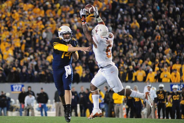 Nov 9, 2013; Morgantown, WV, USA; West Virginia Mountaineers quarterback Paul Millard (14) has his pass deflected by Texas Longhorns cornerback Quandre Diggs (6) in overtime at Milan Puskar Stadium. Mandatory Credit: Evan Habeeb-USA TODAY Sports Nov 9, 2013; Morgantown, WV, USA; West Virginia Mountaineers quarterback Paul Millard (14) has his pass deflected by Texas Longhorns cornerback Quandre Diggs (6) in overtime at Milan Puskar Stadium. Mandatory Credit: Evan Habeeb-USA TODAY Sports