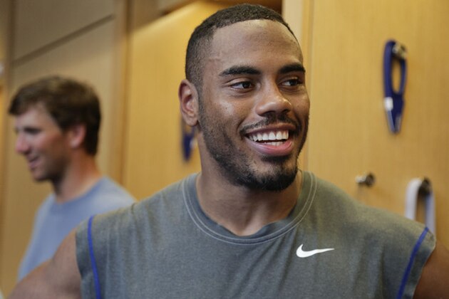 New York Giants running back Rashad Jennings (23) talks with the media in the locker room after workouts at NFL football minicamp, Tuesday, June 17, 2014, in East Rutherford, N.J. (AP Photo/Julie Jacobson)