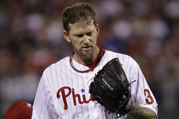 Philadelphia Phillies' pitcher A.J. Burnett walks off the mound to confer with catcher Carlos Ruiz in the fourth inning of a baseball game against the Washington Nationals, Saturday, May 3, 2014, in Philadelphia. (AP Photo/Laurence Kesterson)
