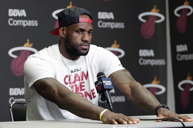 Miami Heat's LeBron James pauses during a news conference in Miami, Tuesday, June 17, 2014. James says he's going on vacation with his family before making any decisions about his future. The Miami Heat held their season-wrapup team meeting on Tuesday afternoon and one of the biggest questions is about the future of the roster. James could become a free agent in a couple of weeks and the four-time MVP says he still has not thought about his plans.(AP Photo/Alan Diaz)