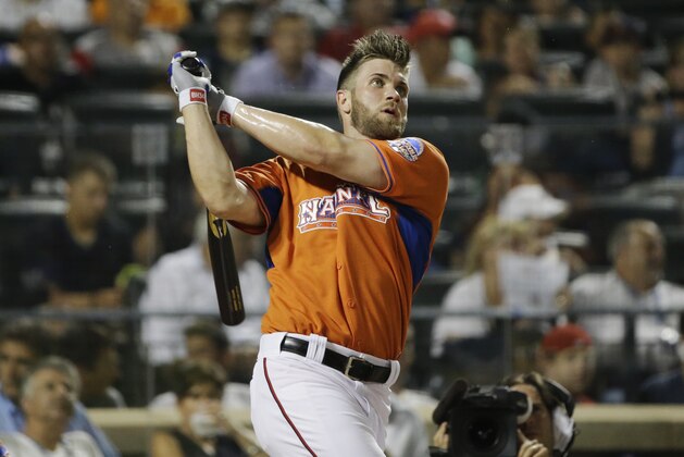 National League's Bryce Harper, of the Washington Nationals, watches his sixth home run in the third round of the MLB All-Star baseball Home Run Derby, on Monday, July 15, 2013 in New York. (AP Photo/Matt Slocum)