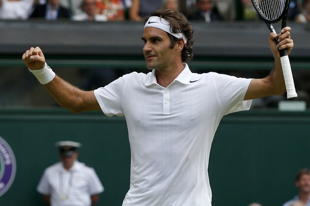 Roger Federer of Switzerland celebrates as he defeats Stan Wawrinka of Switzerland in their men's singles quarterfinal match at the All England Lawn Tennis Championships in Wimbledon, London, Wednesday, July 2, 2014. (AP Photo/Pavel Golovkin)