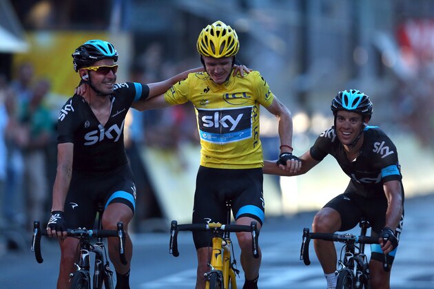 PARIS, FRANCE - JULY 21: Chris Froome of Great Britain and SKY Procycling (C) celebrates as he crosses the finish line flanked by teammates David Lopez (L) and Richie Porte during the twenty first and final stage of the 2013 Tour de France, a processional 133.5KM road stage ending in an evening race around the Champs-Elysees, on July 21, 2013 in Paris, France.  (Photo by Bryn Lennon/Getty Images)