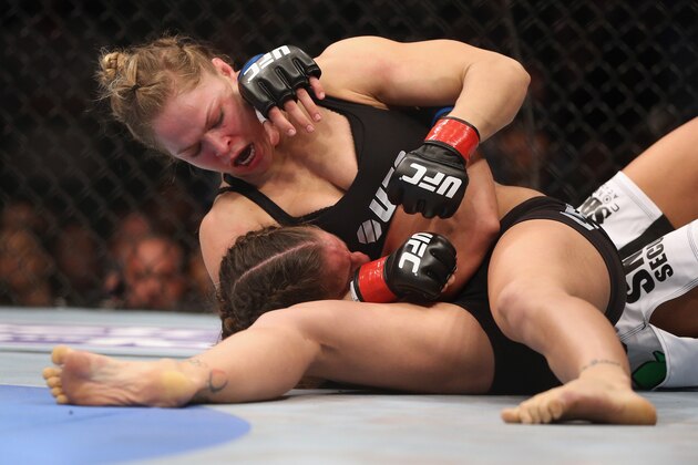 ANAHEIM, CA - FEBRUARY 23: Ronda Rousey hits Liz Carmouche during their UFC Bantamweight Title fight at Honda Center on February 23, 2013 in Anaheim, California. (Photo by Jeff Gross/Getty Images) ANAHEIM, CA - FEBRUARY 23: Ronda Rousey hits Liz Carmouche during their UFC Bantamweight Title fight at Honda Center on February 23, 2013 in Anaheim, California. (Photo by Jeff Gross/Getty Images)
