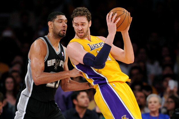 LOS ANGELES, CA - MARCH 19: Pau Gasol #16 of the Los Angeles Lakers handles the ball against Tim Duncan #21 of the San Antonio Spurs at Staples Center on March 19, 2014 in Los Angeles, California. NOTE TO USER: User expressly acknowledges and agrees that, by downloading and/or using this Photograph, user is consenting to the terms and conditions of the Getty Images License Agreement. Mandatory Copyright Notice: Copyright 2014 NBAE (Photo by Noah Graham/NBAE via Getty Images)
