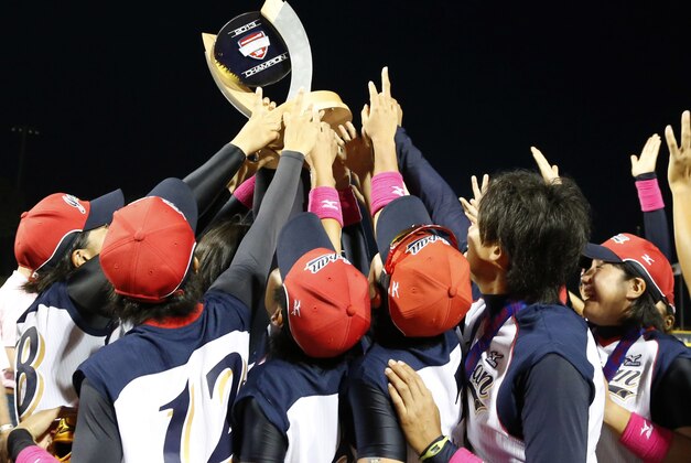 Team Japan holds the trophy high after defeating the United State 6-3 in the World Cup of Softball tournament championship game in Oklahoma City, Sunday, July 14, 2013. (AP Photo/Sue Ogrocki)