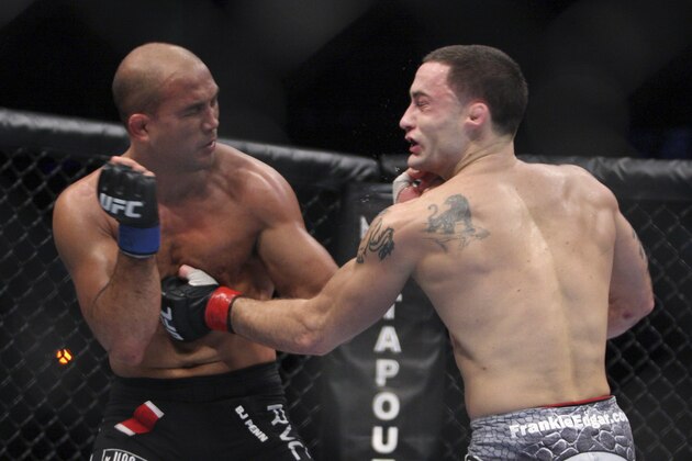 In this Aug. 28, 2010, photo, Frankie Edgar, right, and B.J. Penn trade blows during a UFC fight in Boston. Penn takes on John Fitch on Saturday in a welterweight bout in UFC 127 in Sydney. (AP Photo/Gregory Payan)