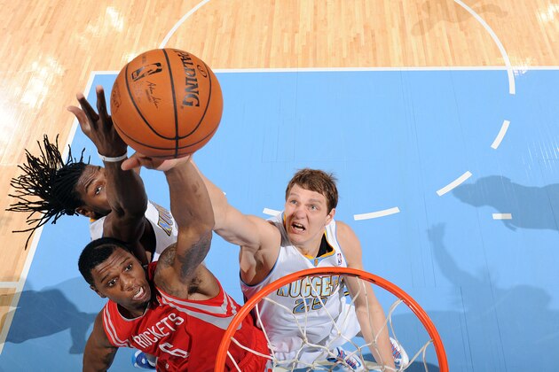 DENVER, CO - APRIL 9: Terrence Jones #6 of the Houston Rockets dunks against Timofey Mozgov #25 of the Denver Nuggets on April 9, 2014 at the Pepsi Center in Denver, Colorado. NOTE TO USER: User expressly acknowledges and agrees that, by downloading and/or using this Photograph, user is consenting to the terms and conditions of the Getty Images License Agreement. Mandatory Copyright Notice: Copyright 2014 NBAE (Photo by Garrett W. Ellwood/NBAE via Getty Images)