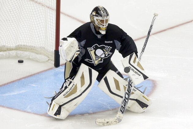 Pittsburgh Penguins goalie Tomas Vokoun, of the Czech Republic, makes a stop on a shot during NHL hockey training camp on Thursday, Sept. 12, 2013 in Pittsburgh. (AP Photo/Keith Srakocic)