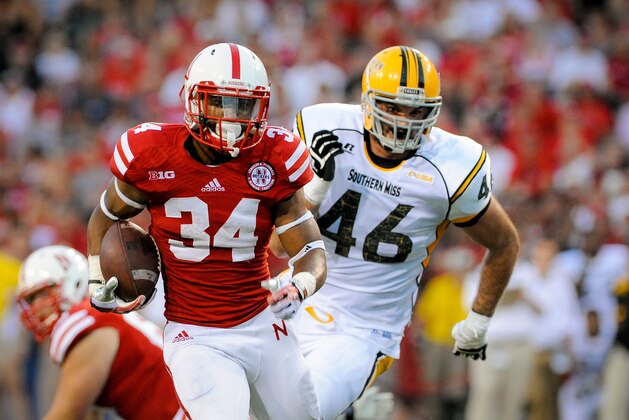 LINCOLN, NE - SEPTEMBER 7: Running back Terrell Newby #34 of the Nebraska Cornhuskers runs awey from defensive lineman Wil Freeman #46 of the Southern Miss Golden Eagles during their game at Memorial Stadium on September 7, 2013 in Lincoln, Nebraska. Nebraska defeated Southern Miss 56-13. (Photo by Eric Francis/Getty Images)