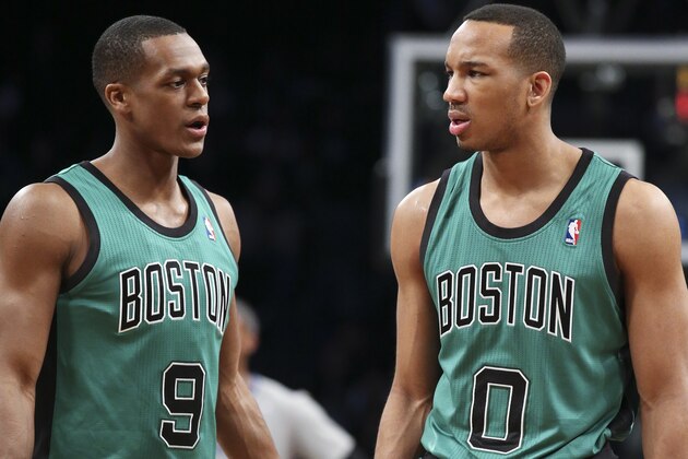 Boston Celtics guard Rajon Rondo (9) and guard Avery Bradley (0) wait for play to resume during the first half of an NBA basketball game against the Brooklyn Nets at the Barclays Center, Friday, March 21, 2014, in New York. The Nets defeated the Celtics, 114-98. (AP Photo/John Minchillo)
