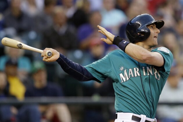 Seattle Mariners' Brad Miller watches his RBI single against the Cleveland Indians in the fourth inning of a baseball game Friday, June 27, 2014, in Seattle. (AP Photo/Elaine Thompson)