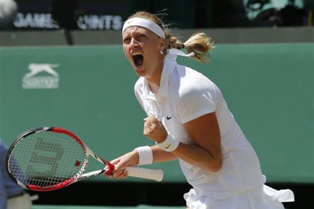 Petra Kvitova of Czech Republic celebrates winning the first set as she plays against Lucie Safarova of Czech Republic during their women’s singles semifinal match at the All England Lawn Tennis Championships in Wimbledon, London, Thursday, July 3, 2014. (AP Photo/Ben Curtis)