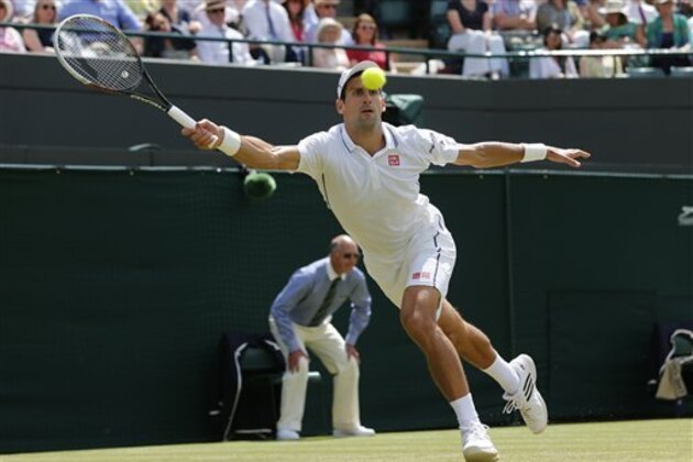 Novak Djokovic of Serbia plays a return to Marin Cilic of Croatia during their men's singles quarterfinal match at the All England Lawn Tennis Championships in Wimbledon, London, Wednesday, July 2, 2014. (AP Photo/Ben Curtis)