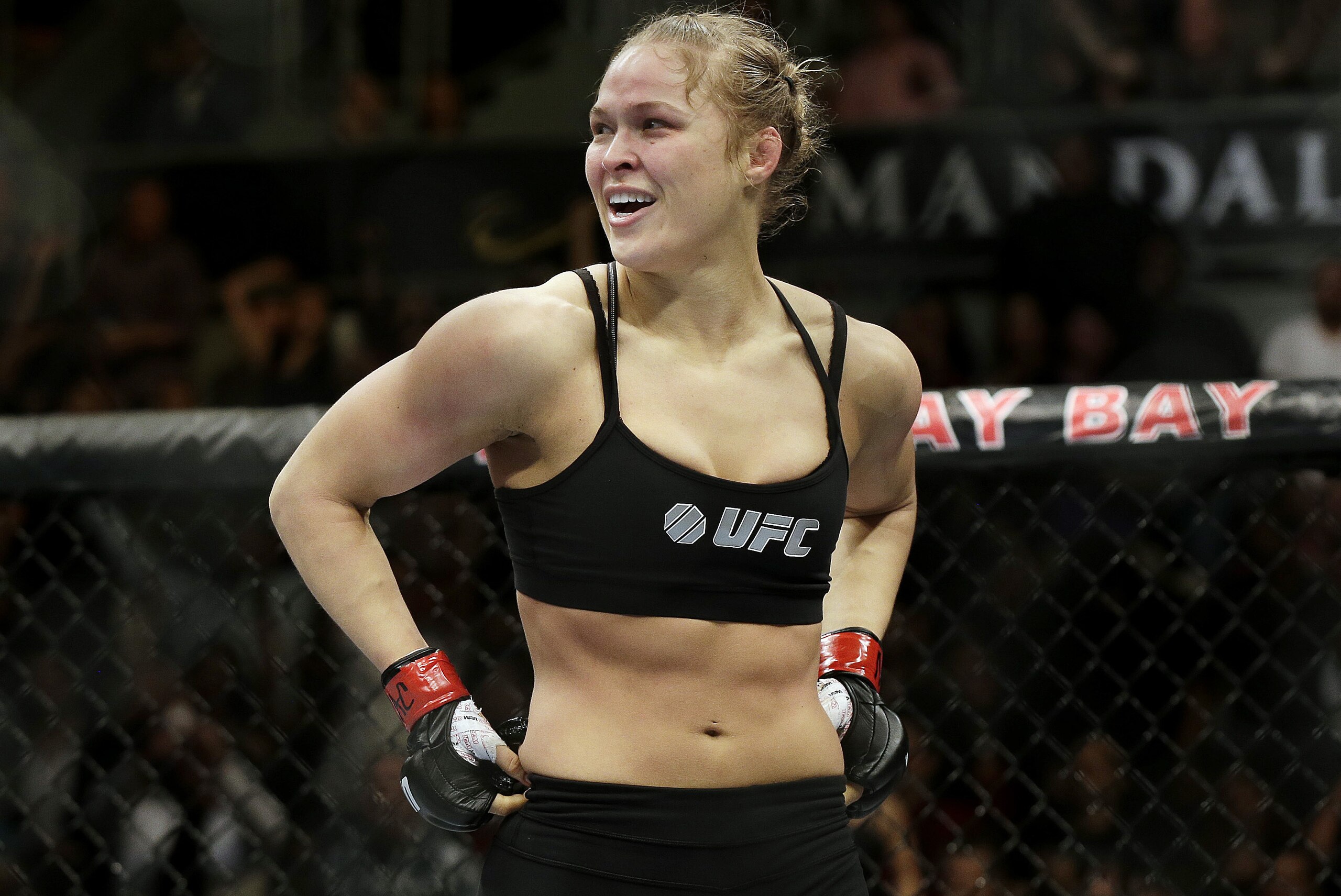 FILE - In this Feb. 22, 2014, file photo, Ronda Rousey looks around after defeating Sara McMann in a UFC 170 mixed martial arts women's bantamweight title bout in Las Vegas. Gina Carano was scheduled to meet with UFC President Dana White on Wednesday April 9, to discuss a return to mixed martial arts for a potential bout with bantamweight champion Rousey. (AP Photo/Isaac Brekken, File)