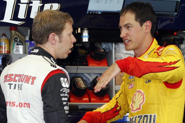 Drivers Brad Keselowski, left, and Joey Logano compare notes in the garage during practice for the NASCAR Sprint Cup series auto race at the Kentucky Speedway in Sparta, Ky., Friday, June 27, 2014. (AP Photo/James Crisp) Drivers Brad Keselowski, left, and Joey Logano compare notes in the garage during practice for the NASCAR Sprint Cup series auto race at the Kentucky Speedway in Sparta, Ky., Friday, June 27, 2014. (AP Photo/James Crisp)