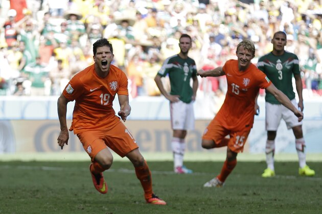 Netherlands' Klaas-Jan Huntelaar celebrates after scoring his side's second goal during the World Cup round of 16 soccer match between the Netherlands and Mexico at the Arena Castelao in Fortaleza, Brazil, Sunday, June 29, 2014.  The Netherlands won the match 2-1. (AP Photo/Natacha Pisarenko)
