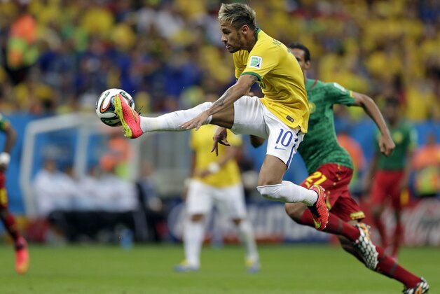 Brazil's Neymar controls a ball during the group A World Cup soccer match between Cameroon and Brazil at the Estadio Nacional in Brasilia, Brazil, Monday, June 23, 2014. (AP Photo/Dolores Ochoa)
