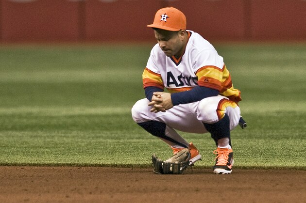 Houston Astros second baseman Jose Altuve reacts after he was unable to knock down a two-run single to right center hit by Tampa Bay Rays' James Loney during the eighth inning of a baseball game on Saturday, June 21, 2014, in St. Petersburg, Fla. (AP Photo/Steve Nesius)