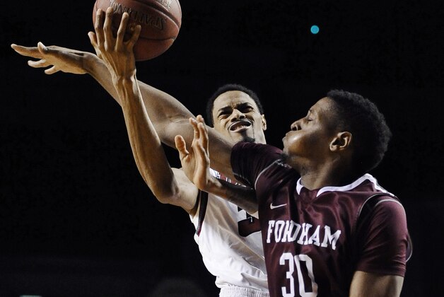 Fordham's Ryan Rhoomes, right, fouls Massachusetts' Raphiael Putney, left, during the second half of an NCAA college basketball game, Sunday, Jan. 26, 2014, in Amherst, Mass. Massachusetts won 90-52. (AP Photo/Jessica Hill)