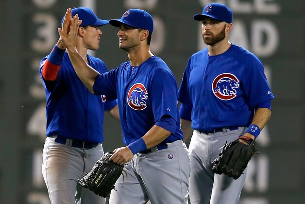 BOSTON, MA - JULY 2: Justin Ruggiano #20 of the Chicago Cubs, who had five runs batted in, celebrates with Chris Coghlan #8  and Nate Schierholtz #19 after sweeping the Boston Red Sox after a 16-9 win at Fenway Park on July 2, 2014 in Boston, Massachusetts.  (Photo by Jim Rogash/Getty Images)