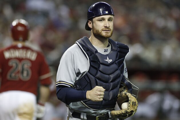 Milwaukee Brewers catcher Jonathan Lucroy, right, clutches his fist after Arizona Diamondbacks Miguel Montero (26) strikes out to end the inning during a baseball game on Wednesday, June 18, 2014, in Phoenix. The Diamondbacks defeated the Brewers 4-3. (AP Photo/Ralph Freso)