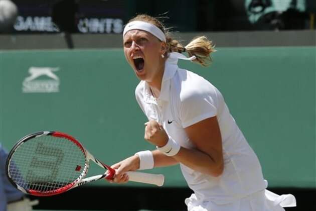 Petra Kvitova of Czech Republic celebrates winning the first set as she plays against Lucie Safarova of Czech Republic during their women’s singles semifinal match at the All England Lawn Tennis Championships in Wimbledon, London, Thursday, July 3, 2014. (AP Photo/Ben Curtis)