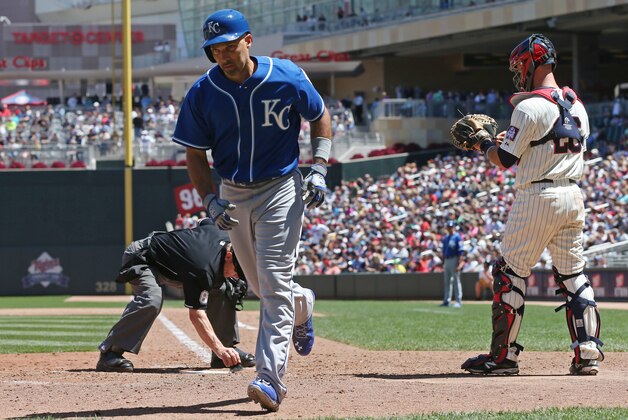 Kansas City Royals' Raul Ibanez heads to the dugout after his solo home run off Minnesota Twins pitcher Casey Fien in the eighth inning of a baseball game, Wednesday, July 3, 2014, in Minneapolis. The Royals won 4-0. (AP Photo/Jim Mone)