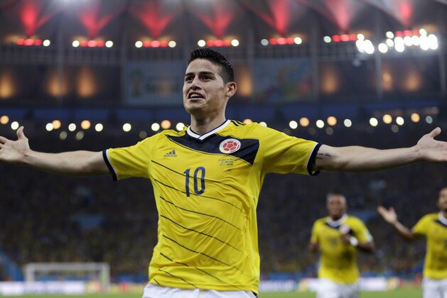 FILE - In this June 28, 2014, file photo, Colombia's James Rodriguez celebrates after scoring the opening goal during the World Cup round of 16 soccer match between Colombia and Uruguay at the Maracana Stadium in Rio de Janeiro, Brazil. Never before has the star-crossed nation made the quarterfinals. There is even waxing poetic about World Cup unity accelerating the pace of 18-month-old peace talks to end a half-century of conflict that has claimed some 220,000 lives. (AP Photo/Natacha Pisarenko)