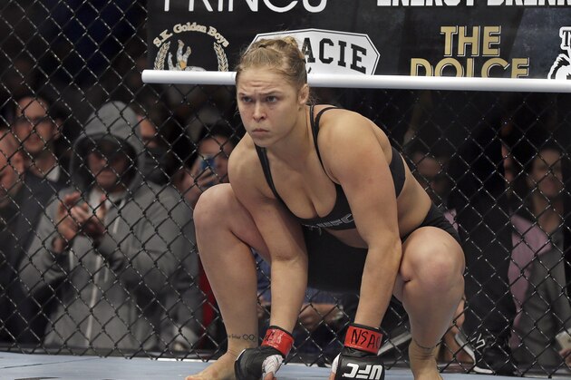 In this Feb. 22, 2014 photo, Ronda Rousey prepares for a UFC 170 mixed martial arts women's bantamweight title fight against Sara McMann in Las Vegas. Rousey is constructing her escape hatch out of mixed martial arts, even if she’s not planning to use it just yet. The UFC bantamweight champion has turned her celebrity and charisma into a budding career as an action film star. Many MMA fighters dream about it, but Rousey is actually doing it: With upcoming parts in “The Expendables 3,” the newest “Fast and Furious” chapter and the “Entourage” movie, she’s seeking success outside the cage even while her fighting career is near its peak. (AP Photo/Isaac Brekken)