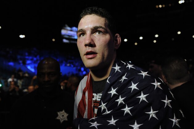 Chris Weidman, of Baldwin, N.Y., walks after defeating Anderson Silva, of Brazil, during the UFC 168 mixed martial arts middleweight championship bout on Saturday, Dec. 28, 2013, in Las Vegas. Weidman won during the second round by a technical knockout after Silva was injured. (AP Photo/David Becker)