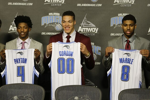 Orlando Magic draft picks Elfrid Payton (4) Aaron Gordon (00) and Roy Devyn Marble (8) attend a news conference introducing them to the NBA basketball team, Friday, June 27, 2014, in Orlando, Fla. (AP Photo/John Raoux)