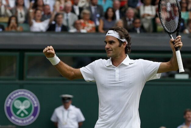 Roger Federer of Switzerland celebrates as he defeats Stan Wawrinka of Switzerland in their men's singles quarterfinal match at the All England Lawn Tennis Championships in Wimbledon, London, Wednesday, July 2, 2014. (AP Photo/Pavel Golovkin)