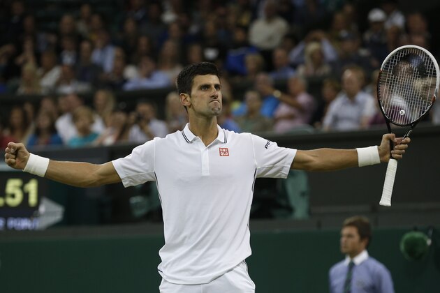 Novak Djokovic of Serbia celebrates defeating Jo-Wilfried Tsonga of France in their men's singles match at the All England Lawn Tennis Championships in Wimbledon, London, Monday, June 30, 2014. (AP Photo/Pavel Golovkin)
