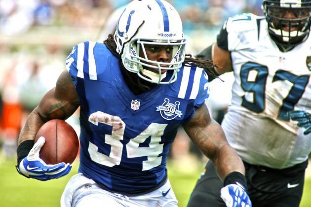 Sep 29, 2013; Jacksonville, FL, USA; Indianapolis Colts running back Trent Richardson (34) runs past Jacksonville Jaguars defensive tackle Roy Miller (97) in the second quarter of their game at EverBank Field. Mandatory Credit: Phil Sears-USA TODAY Sports