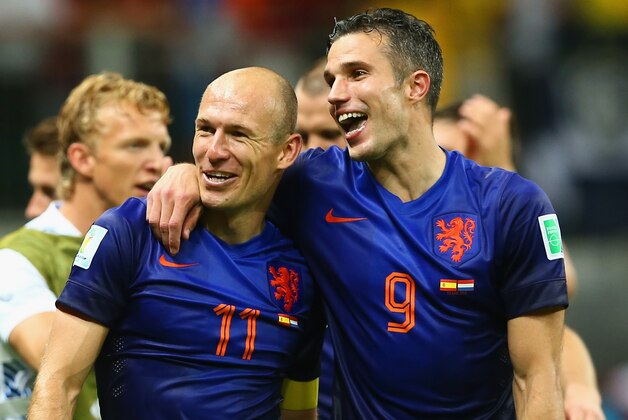 SALVADOR, BRAZIL - JUNE 13:  Arjen Robben (L) and Robin van Persie of the Netherlands walk off the field after scoring two goals each and defeating Spain 5-1 during the 2014 FIFA World Cup Brazil Group B match between Spain and Netherlands at Arena Fonte Nova on June 13, 2014 in Salvador, Brazil.  (Photo by Quinn Rooney/Getty Images)