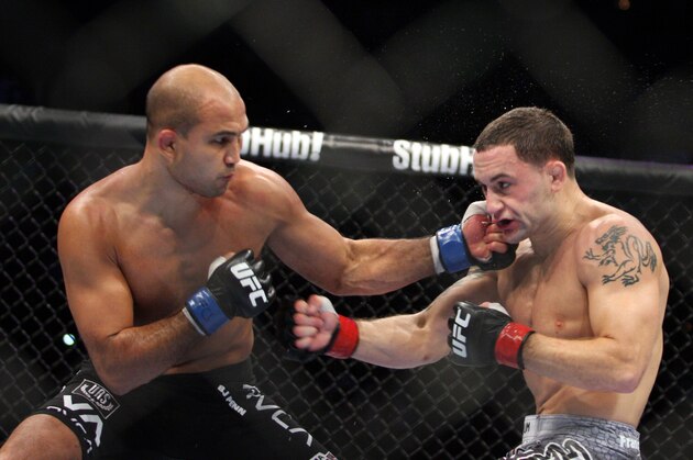 Frankie Edgar,right, in action against B. J. Penn during their lightweight title fight on Saturday, Aug. 28, 2010  at the TD Garden in Boston, MA.  Edgar retained his title via unanimous decision.   (AP Photo/Gregory Payan)
