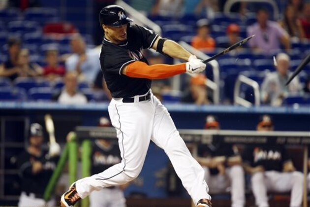 CORRECTS SPELLING OF FIRST NAME TO GIANCARLO, NOT GIANCARIO - Miami Marlins' Giancarlo Stanton breaks his bat during the first inning of a baseball game against the New York Mets, Saturday, June 21, 2014, in Miami. (AP Photo/J Pat Carter)