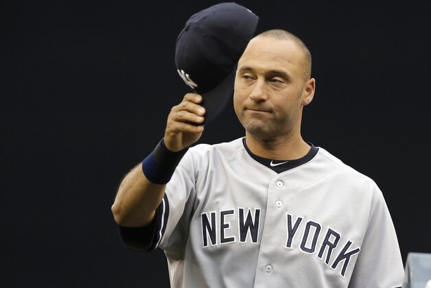 New York Yankees' Derek Jeter tips his cap to fans as he his honored during a pre-game ceremony before a baseball game against the Seattle Mariners, Tuesday, June 10, 2014, in Seattle. (AP Photo/Ted S. Warren)