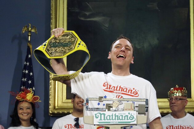 Seven-time hot dog eating champion, Joey Chestnut, poses while weighing in during a news conference to promote the upcoming Nathan's Famous Fourth of July International Hot-Dog Eating Contest tomorrow Thursday, July 3, 2014, at City Hall in New York. (AP Photo/Frank Franklin II)