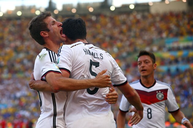 RIO DE JANEIRO, BRAZIL - JULY 04:  Mats Hummels of Germany (C) celebrates scoring his team's first goal with Thomas Mueller (L) and Mesut Oezil during the 2014 FIFA World Cup Brazil Quarter Final match between France and Germany at Maracana on July 4, 2014 in Rio de Janeiro, Brazil.  (Photo by Julian Finney/Getty Images)