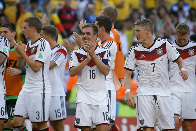 Germany's Philipp Lahm, center, smiles at the end of  the World Cup quarterfinal soccer match between Germany and France at the Maracana Stadium in Rio de Janeiro, Brazil, Friday, July 4, 2014. Germany won the match 1-0.  . (AP Photo/David Vincent)