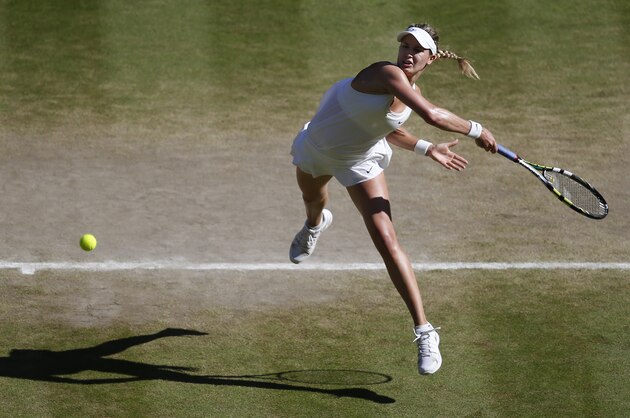 Eugenie Bouchard of Canada leaps as she plays a rerun to Simona Halep of Romania during their women's singles semifinal match at the All England Lawn Tennis Championships in Wimbledon, London, Thursday, July 3, 2014. Eugenie Bouchard of Canada won the match and will play Petra Kvitova of Czech Republic in the final on Saturday.(AP Photo/Sang Tan, Pool)