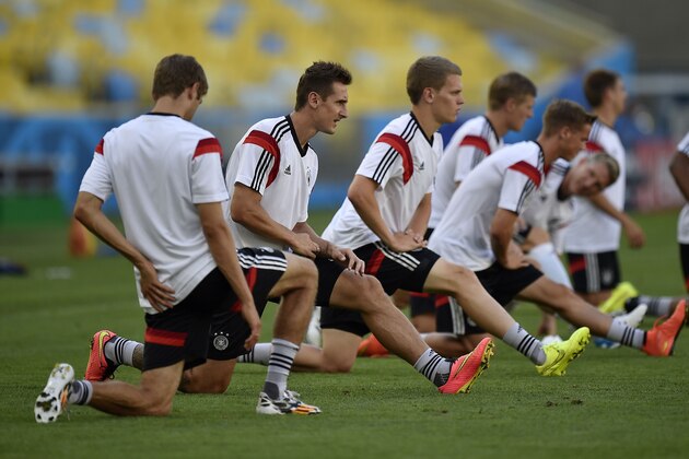 Germany's Miroslav Klose, 2nd from left, stretches during an official training session one day before the World Cup quarterfinal soccer match between Germany and France at the Maracana Stadium in Rio de Janeiro, Brazil, Thursday, July 3, 2014. (AP Photo/Martin Meissner)