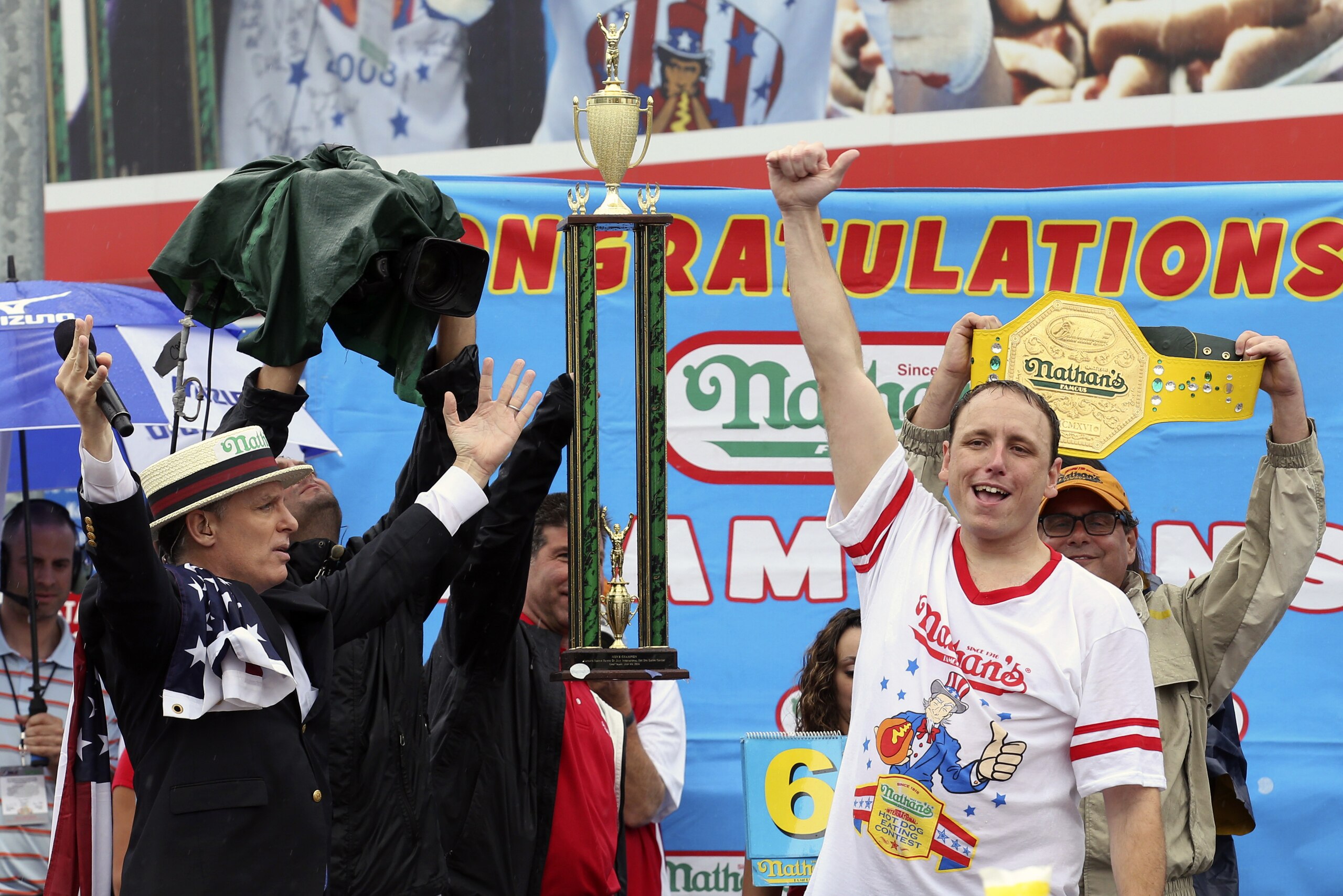 Joey Chestnut raises his fist in the air after winning Nathan's Famous Fourth of July International Hot Dog Eating contest at Coney Island, Friday, July 4, 2014, in New York. Chestnut finished first by consuming 61 hotdogs and buns. (AP Photo/John Minchillo)