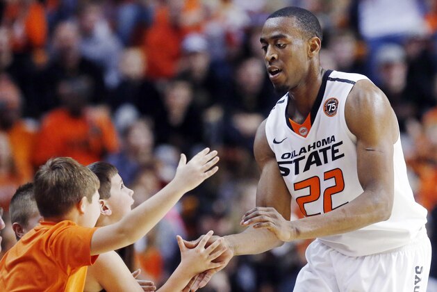 Oklahoma State wing Markel Brown (22) celebrates with fans during the second half of an NCAA college basketball game against Robert Morris in Stillwater, Okla., Monday, Dec. 30, 2013. Oklahoma State won 92-66. (AP Photo/Sue Ogrocki)