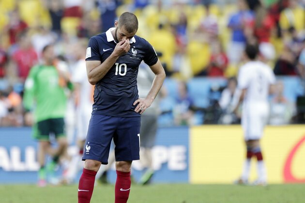 France's Karim Benzema stands on the pitch after Germany defeated France 1-0 to advance to the semifinals during the World Cup quarterfinal soccer match at the Maracana Stadium in Rio de Janeiro, Brazil, Friday, July 4, 2014.  Benzema missed a near goal in the closing minutes to equalize the match. (AP Photo/Matthias Schrader)